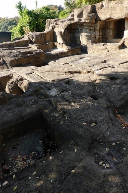 一部復元された上行寺東遺跡。石窟仏を納めたやぐらと、岩山を削って柱穴をあけて建てた寺院跡とみられる。