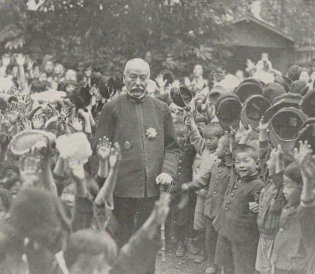 昭和5年（1930）、自邸前で少国民に囲まれる平八郎（『東郷平八郎全集』より。出典：国立国会図書館デジタルコレクション）